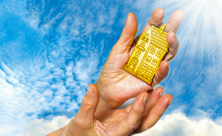 bright picture of woman holding wooden houseの写真素材