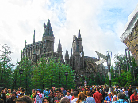 Orlando, USA - January 02, 2014: Visitors enjoying the Harry Potter themed attractions and shops at the Hogsmeade Village inside Universal Studios Islands of Adventure theme parkのeditorial素材