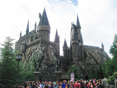 Orlando, USA - January 02, 2014: Visitors enjoying the Harry Potter themed attractions and shops at the Hogsmeade Village inside Universal Studios Islands of Adventure theme parkのeditorial素材