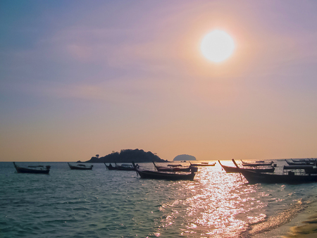 Small boats at the Andaman Sea in sunsetの写真素材