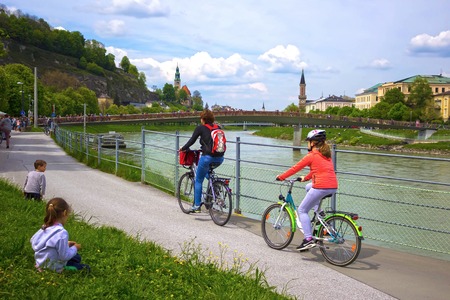 Salzburg, Austria - May 01, 2017: Cyclist on the embankment in Salzburg