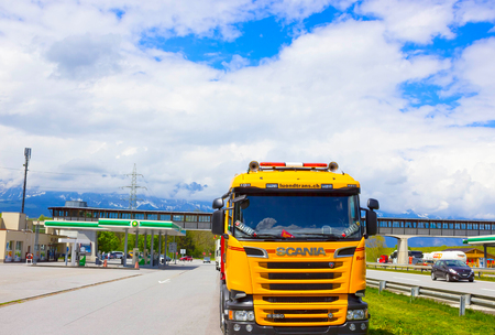 Salzburger Land, Austria - MAY 3, 2017: Yellow Scania truck is parked near the gas stationのeditorial素材