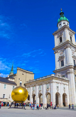 Salzburg, Austria - May 01, 2017: The golden ball statue with a man on the top sculpture, Kapitelplatz Square, Salzburg,のeditorial素材