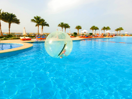 Sharm El Sheikh, Egypt - April 09, 2017: Little girl in an inflatable balloon, having fun on the water.のeditorial素材