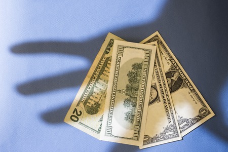 Shade From A Hand On Moneyの写真素材