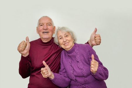 Senior couple showing ok thumbs up isolated on white backgroundの写真素材
