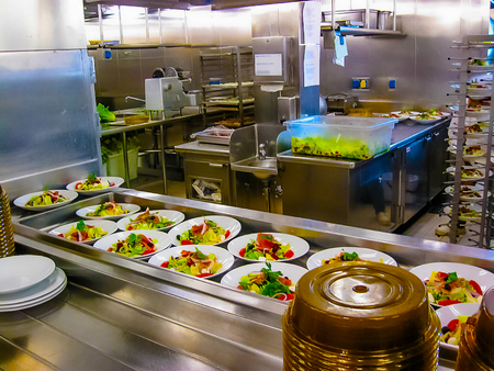 The kitchen with plates ready for serving dinner on a cruise ship