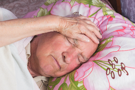 Elderly 80 plus year old man in a home bed.の写真素材