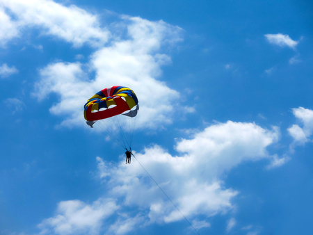 Couple flying high from glider parachutの写真素材