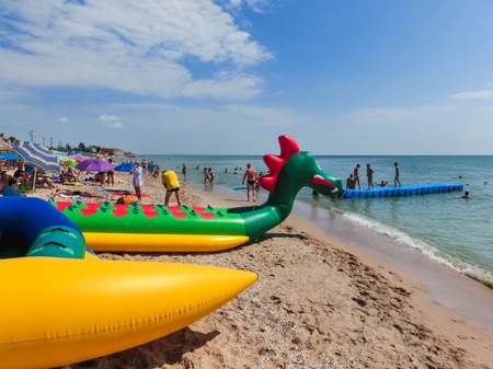 Berdyansk, Ukraine June 30, 2018: beach resort seasonon the coast of the Azov Sea. People are sunbathing on the beach.のeditorial素材
