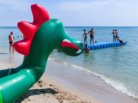 Berdyansk, Ukraine June 30, 2018: beach resort seasonon the coast of the Azov Sea. People are sunbathing on the beach.のeditorial素材