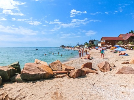 Berdyansk, Ukraine June 30, 2018: beach resort seasonon the coast of the Azov Sea. People are sunbathing on the beach.のeditorial素材