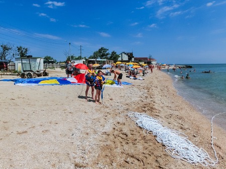 Berdyansk, Ukraine June 30, 2018: Couple preparing to fly from glider parachutのeditorial素材