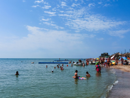 Berdyansk, Ukraine June 30, 2018: beach resort seasonon the coast of the Azov Sea. People are sunbathing on the beach.のeditorial素材