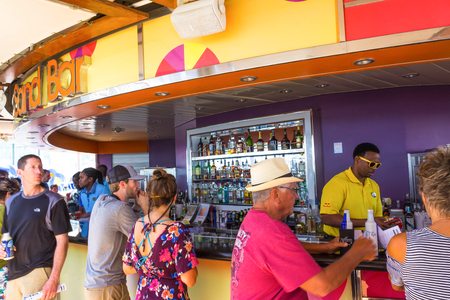 Cape Canaveral, USA - APRIL 29, 2018: The waiter with alcoholic drinks at luxury cruise ship Oasis of the Seas by Royal Caribbean.のeditorial素材