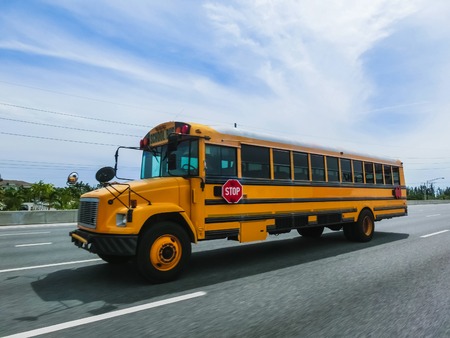 Orlando, Florida, USA - May 10, 2018: The traditional school buss on freeway road at Orlando, Florida, USAのeditorial素材