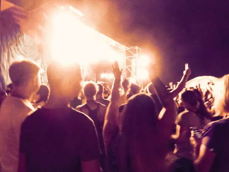 The party, concert concept. Crowd raising their hands and enjoying great rock festival. blur bokeh for background.の写真素材