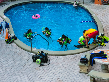 Ft.Lauderdale, USA - May 12, 2018: People are taking initial SCUBA lessons in a hotel pool at Ft.Lauderdale Beach Resort Hotel.のeditorial素材