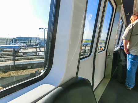Frankfurt, Germany - April 28, 2018: The people at skyline train, the free automatic shuttle rail service at Frankfurt airport which links two airport terminals. View from window at Frankfurt, Germany on April 28, 2018のeditorial素材