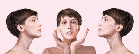 Beautiful woman close up over a pastel background with arrows. Lifting and aging conceptの写真素材