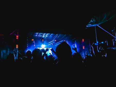 The party, concert concept. Crowd raising their hands and enjoying great rock festival. blur bokeh for background.の写真素材