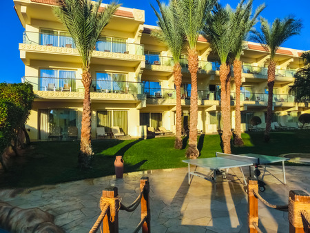 Sharm El Sheikh, Egypt - December 31, 2018:Tropical luxury Xperience Sea Breeze Resort on Red Sea beach. Palm trees and other landscaped trees on the background of a hotel buildings in Egypt, Sharm el-Sheikhのeditorial素材