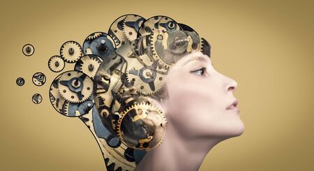 Thinking businesswoman with gear mechanisms on her headの写真素材