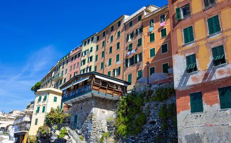 Colorful buildings and beach at Camogli on sunny summer day, Liguria, Italy