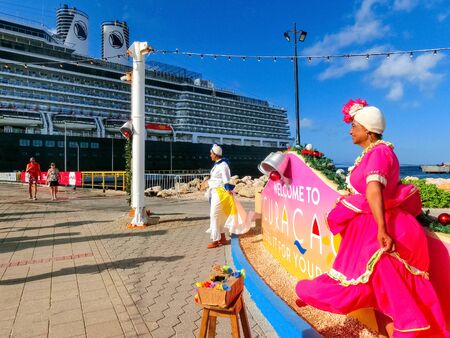 Willemstad, Curacao, Netherlands - December 5, 2019: View of local women welcoming tourists at port in Curacao.のeditorial素材