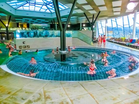 Michalovce, Slovakia - December 30, 2019: People resting at swimming pool in Thermal park Siravaのeditorial素材