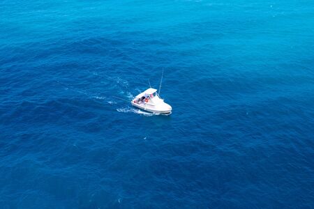 Motorized cruiser boat in blue sea of Caribbean island of Aruba.