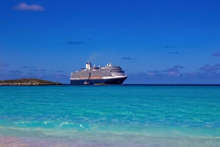 The view of empty beach on Half Moon Cay island at Bahamas. Blue water and white sand