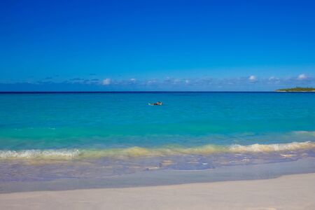 The view of beach on Half Moon Cay island at Bahamas. Blue water and white sand