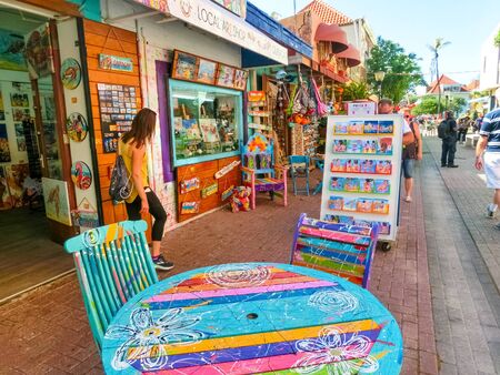 Willemstad, Curacao, Netherlands - December 5, 2019: People going at street with gifts and souvenirs from local vendors at Willemstad, Curacao, Netherlands on December 5, 2019.のeditorial素材