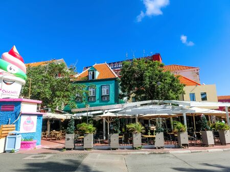 Willemstad, Curacao, Netherlands - December 5, 2019: Specific coloured buildings at street in Curacaoのeditorial素材