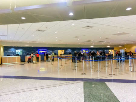 Miami, Florida, USA - November 29, 2019: The people near Alamo rental car office at Miami airport at...