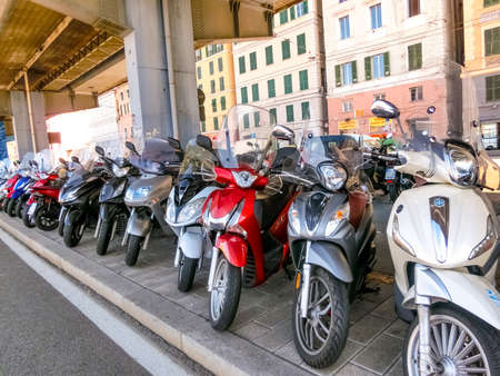 Genoa, Liguria, Italy - September 11, 2019: The motorcycle parking in the central street in the city...