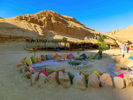 Sharm El Sheikh, Egypt - February 17, 2020: The people at lounge and relax area at bedouin village in Sahara desert on mountain landscape at Dahabのeditorial素材