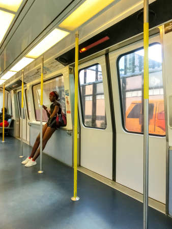 Miami, USA - November 30, 2019: The young african woman at Skytrain Mover wagon at daytime at Downtown Miami.のeditorial素材