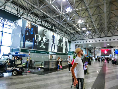 Milan, Italy - September 18, 2019: People in departure area of Milan Malpensa Airport Terminal 2 used by EasyJet - largest airport in Northern Italy, currently the 28th busiest airport in Europe.のeditorial素材