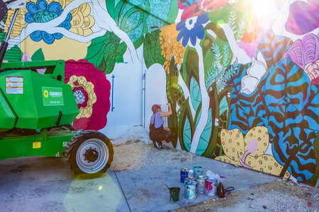 Miami, United States of America - November 30, 2019: The artist working at Art Wynwood in Miami, USA. Wynwood is a neighborhood in Miami Florida which has a strong art culture presence and murals can be seen everywhere.のeditorial素材