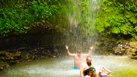 Soufriere, Saint Lucia - May 12, 2016: The tourists swimming at the waterfall at the Botanical Gardens in Saint Lucia at island at Caribbean seaのeditorial素材