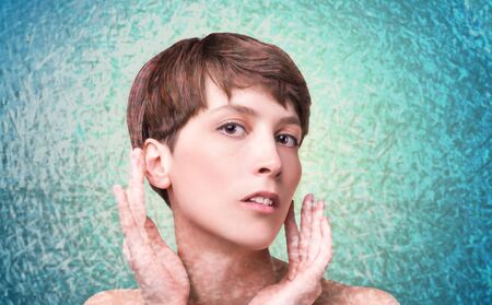 Beautiful woman. Female face close up. Portrait of young caucasian woman. Art collage. Fresh skin and beauty concept. Short haircut, long neck, perfect skinの写真素材