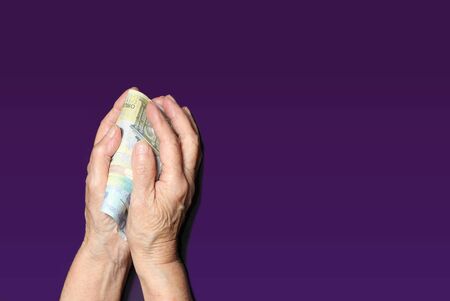 Senior woman holding euro cash. Concept of accounting, financial adviser
