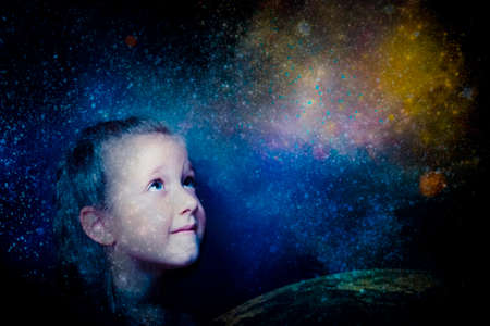 Childhood and dream concept. Conceptual image with girl dreaming about big future, outter space, stars, planets. Creative art collage with double exposureの写真素材
