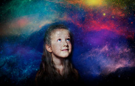 Childhood and dream concept. Conceptual image with girl dreaming about big future, outter space, stars, planets. Creative art collage with double exposureの写真素材