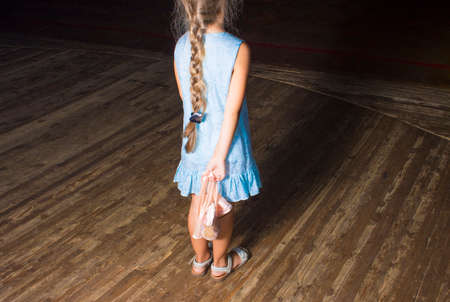 Little girl dreaming a dancing ballet on the stage. Childhood concept.の写真素材