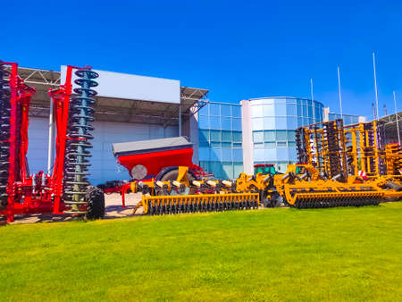 Large disc plow, towing for tractors to plow fields, against the sky
