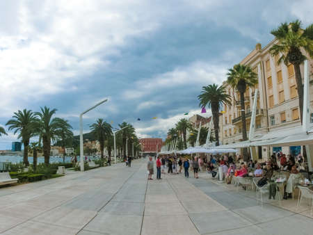 Split, Croatia - May 08, 2014: The people resting on wide promenade in old city in Split, Croatia on a cloudy day on May 08, 2014. It is well preserved and important popular touristic attraction of Dalmatiaのeditorial素材