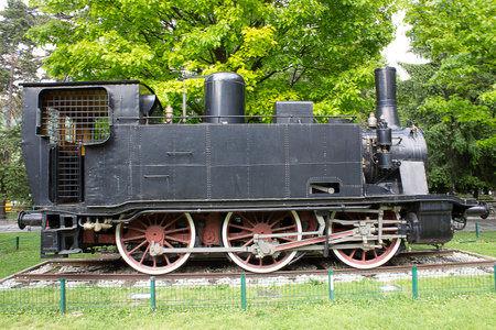 Como, Italy - May 03, 2017: Old steam locomotive preserved and on display in a public park in Como...